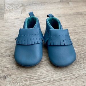 Baby Moccasins in blue sized: 6-12 mo. Like new condition- worn once